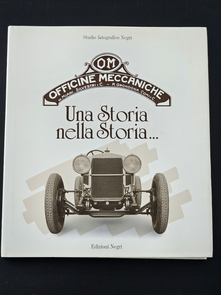 Book cover with OM Officine Meccaniche logo, title text, and vintage racing car