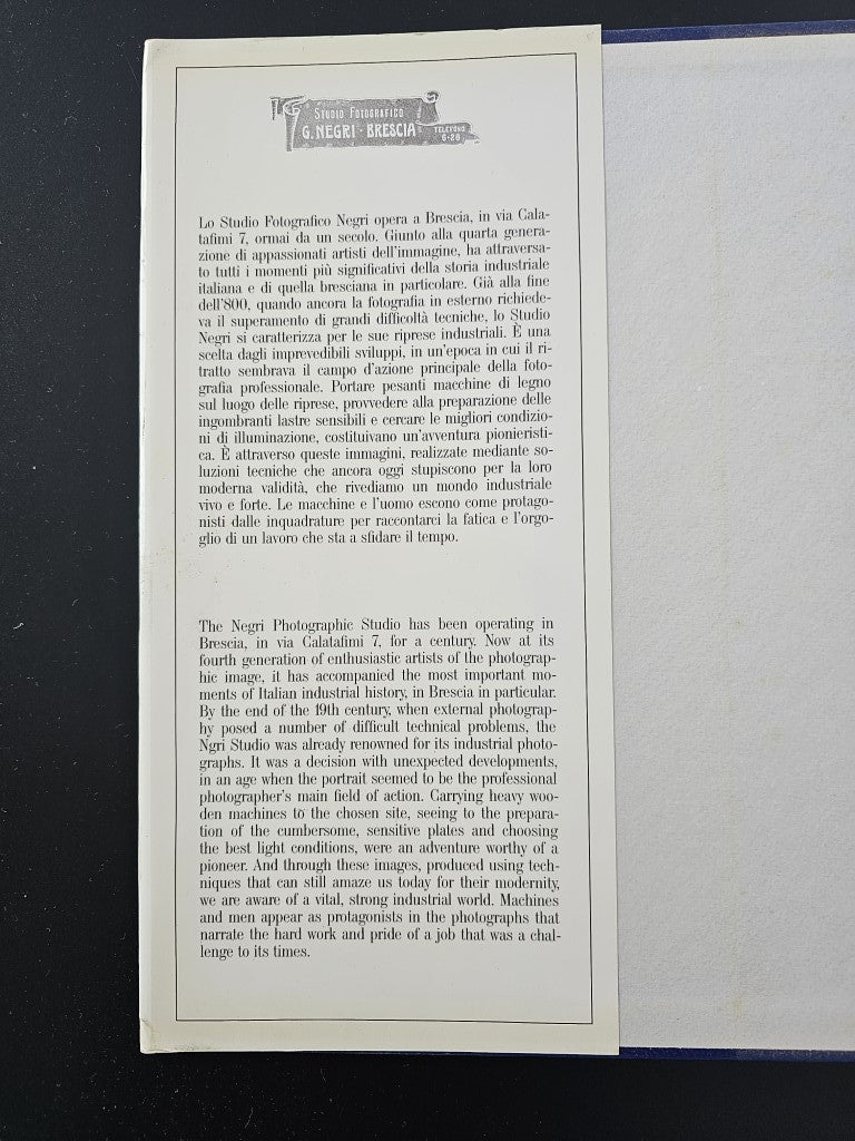 Photo history book open to a page of printed text with a heading at top.