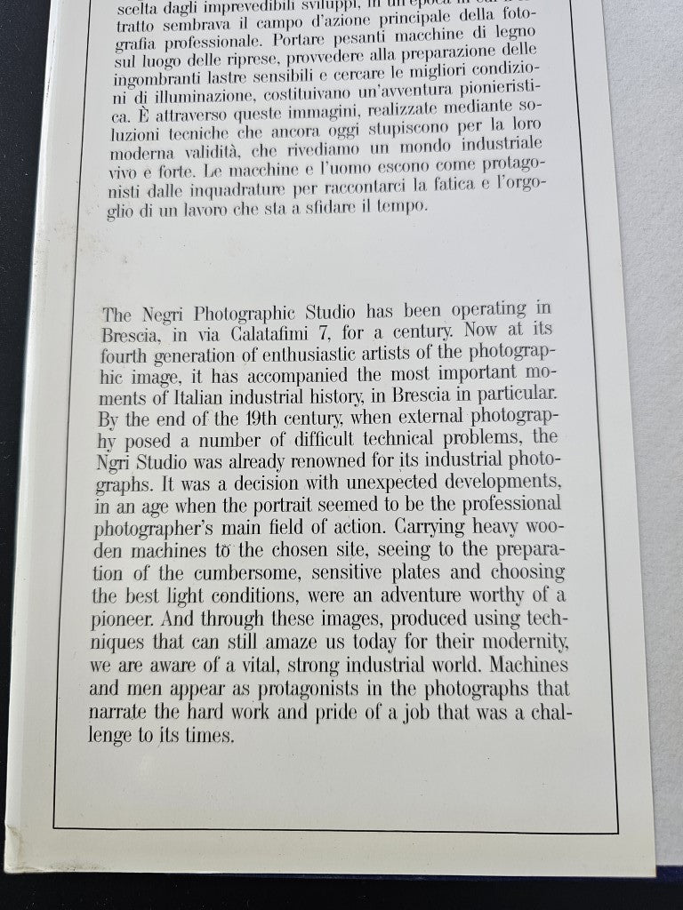 Photo history book page with a bordered block of printed text.