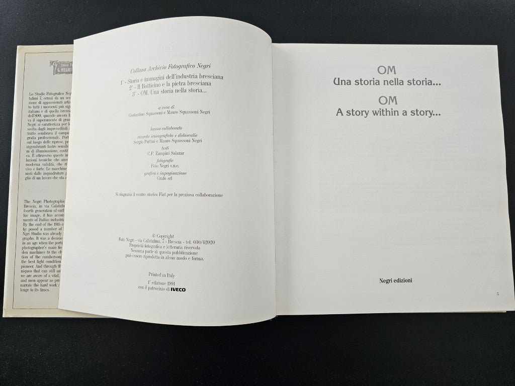 Photo history book open with centered title lines on both pages.