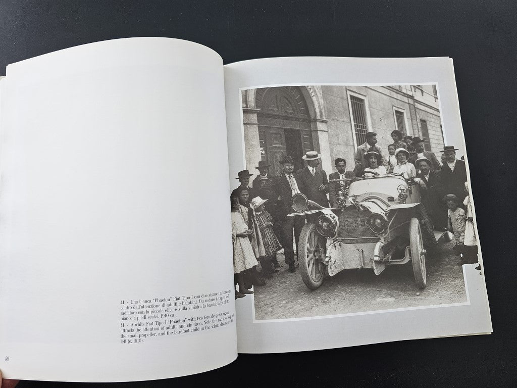 Photo history book open to a page with a black-and-white car photograph.