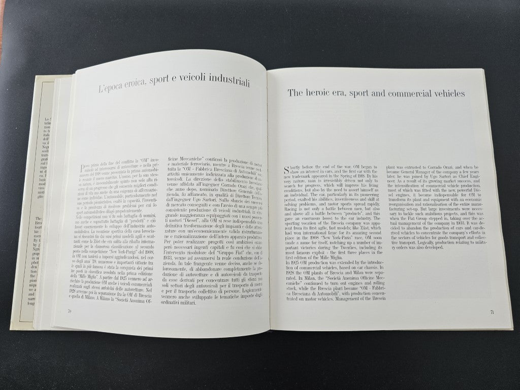 Open book page spread with dense text about industrial vehicles and history