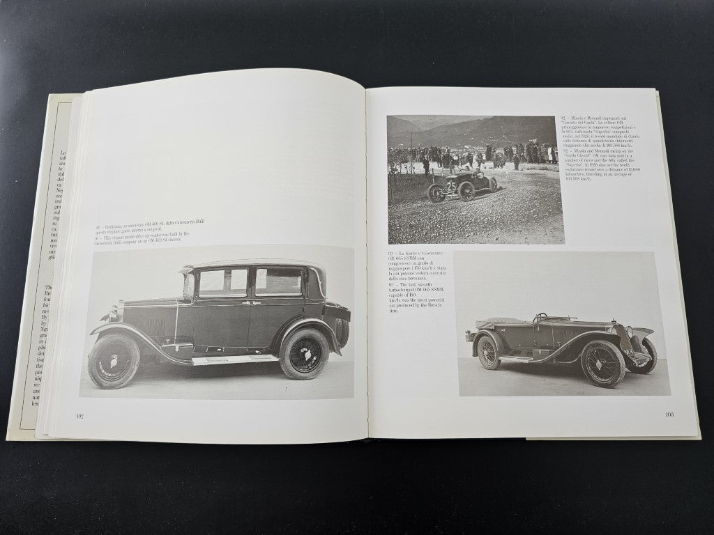 Open book with black-and-white photos of vintage cars from different angles