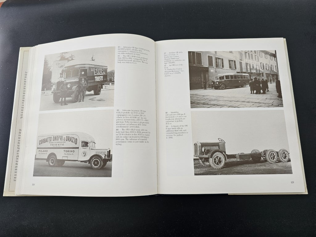 Open book with black-and-white photos of trucks and vintage cars on streets