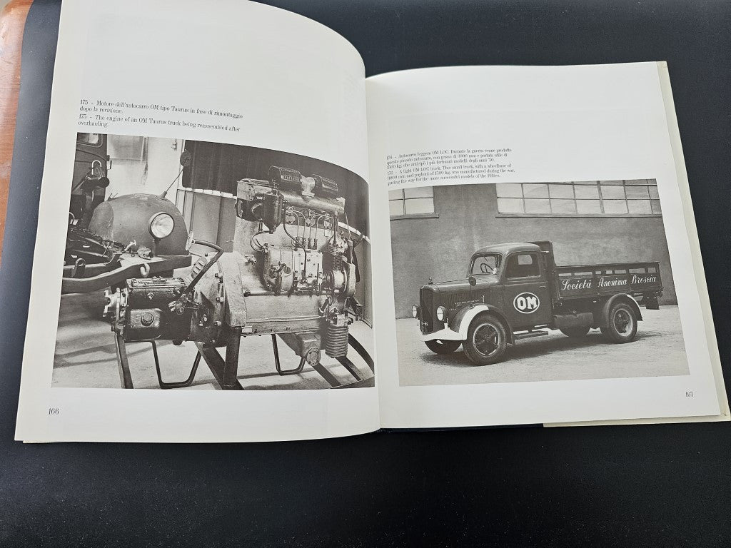 Open book with black-and-white photos of vintage vehicles and workshop machinery