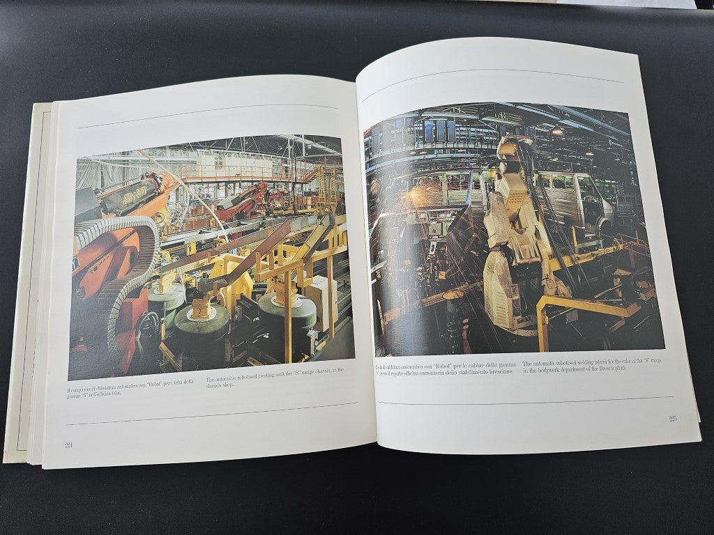 Open book showing color factory photographs with workers on production lines