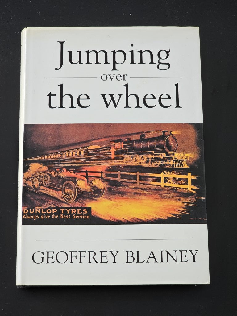 Hardcover book with white cover, “Jumping over the wheel” title and author name