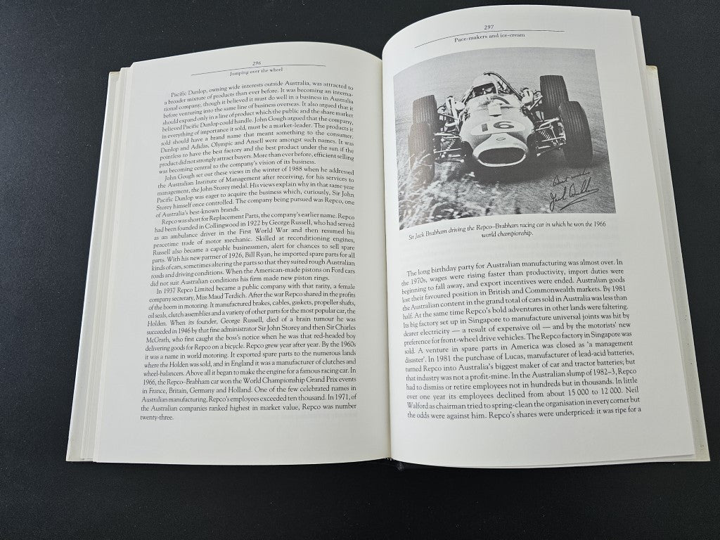 Open book spread with dense text and black-and-white machinery photo on right