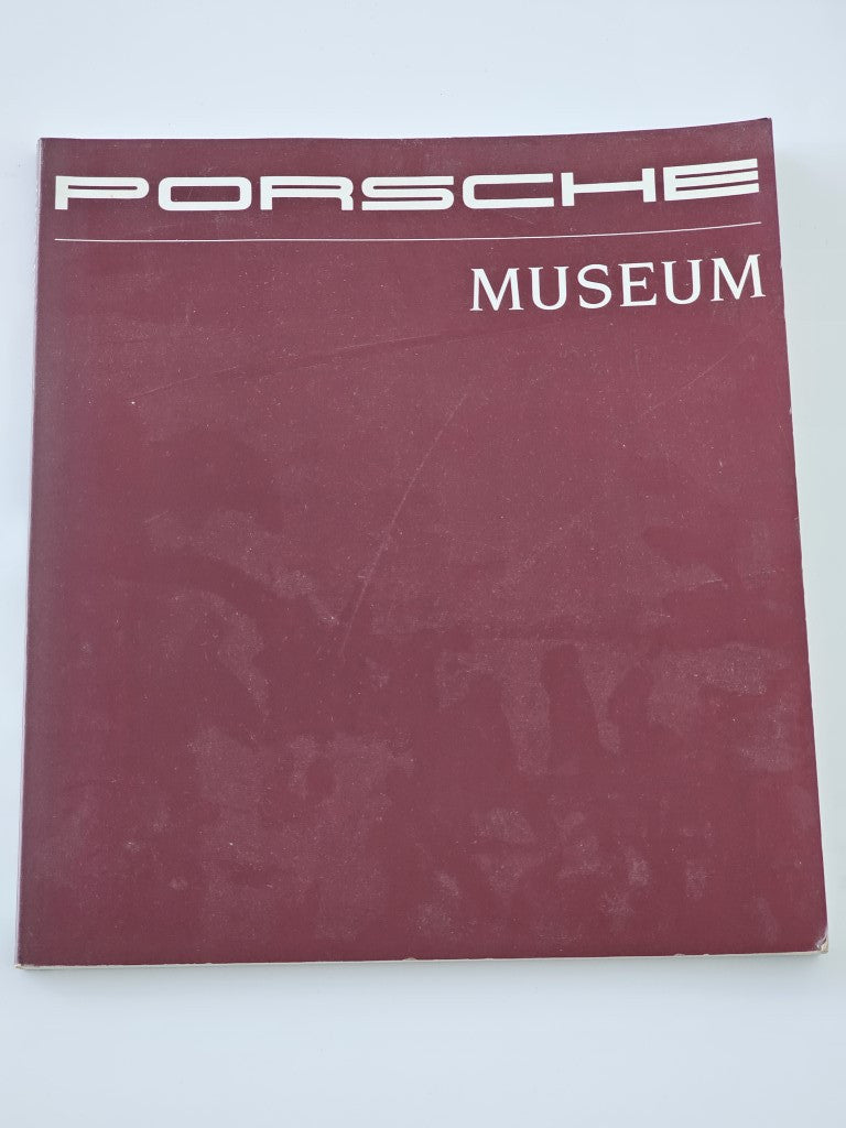 Porsche Museum vehicle documentation book, maroon hardcover with Porsche logo and Museum title