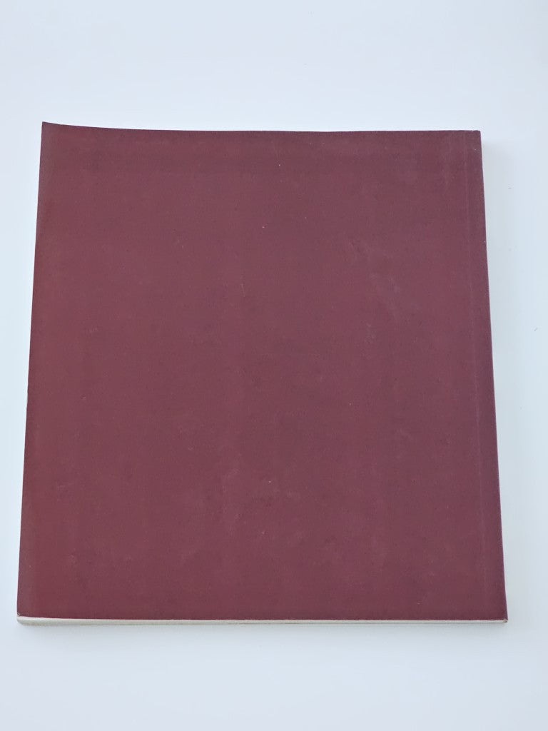 Maroon hardcover book with plain cover and subtle surface texture