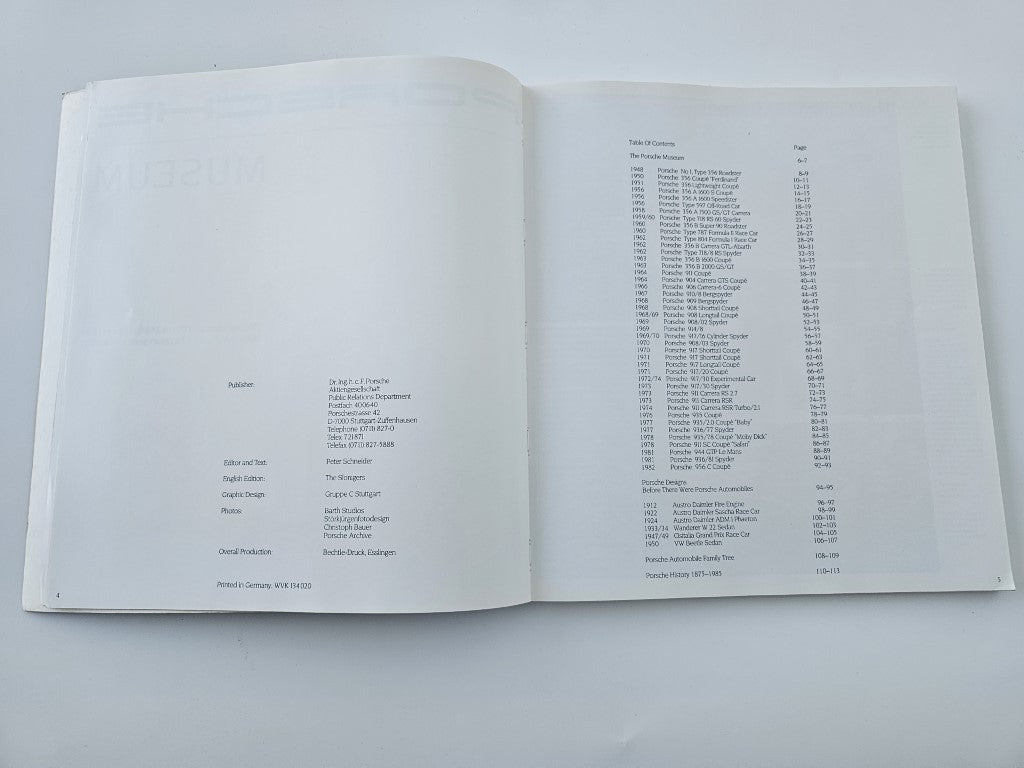 Porsche Museum vehicle documentation book, open pages with table of exhibits list