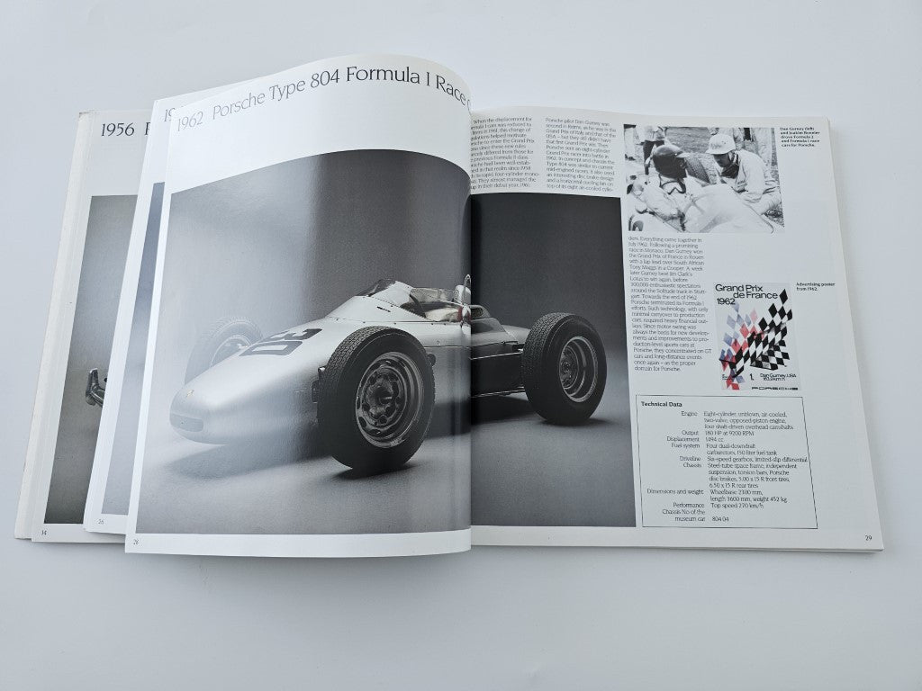 Open book with a white formula race car photo, plus a text page and inset image.