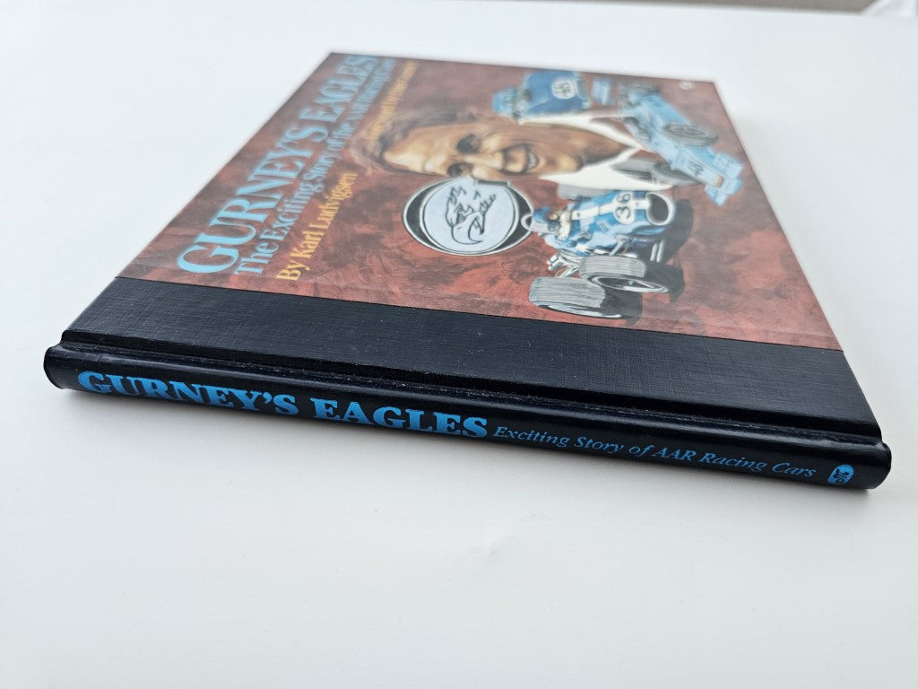 Hardcover book spine and title text, with racing cover art and black spine.