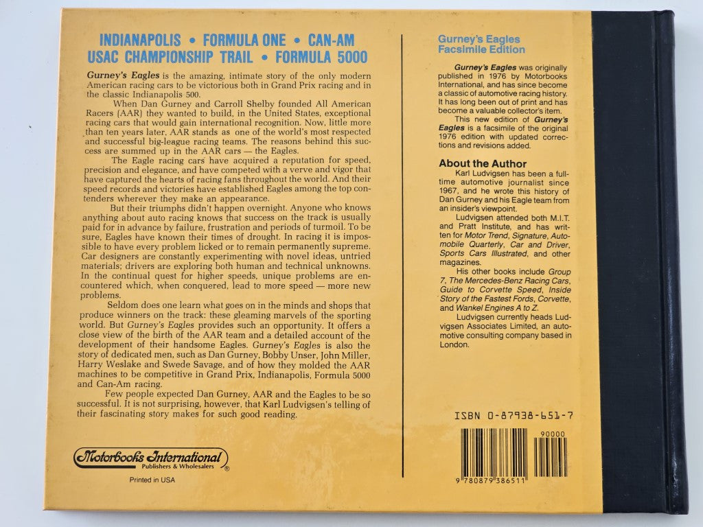 Book back cover with racing text, barcode, and publication details on a yellow page.