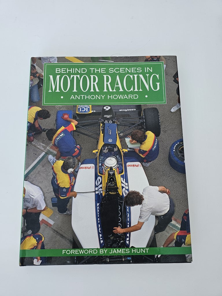 Motor racing book with illustrated cover featuring race team members and motorcycle