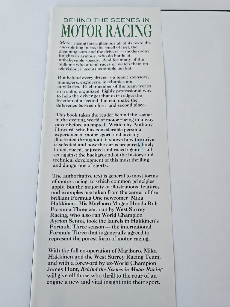 Motor racing book open to a page of printed text
