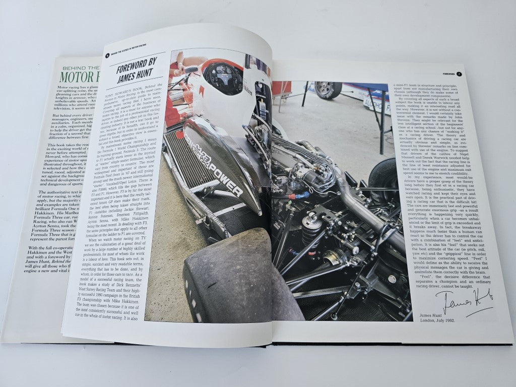 Motor racing book open with large engine photo and surrounding text columns