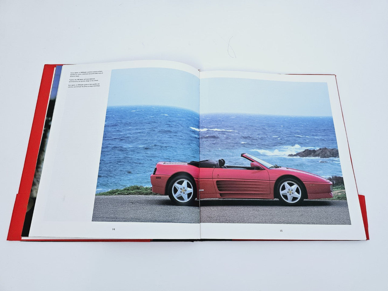 Open book page with red sports car photo