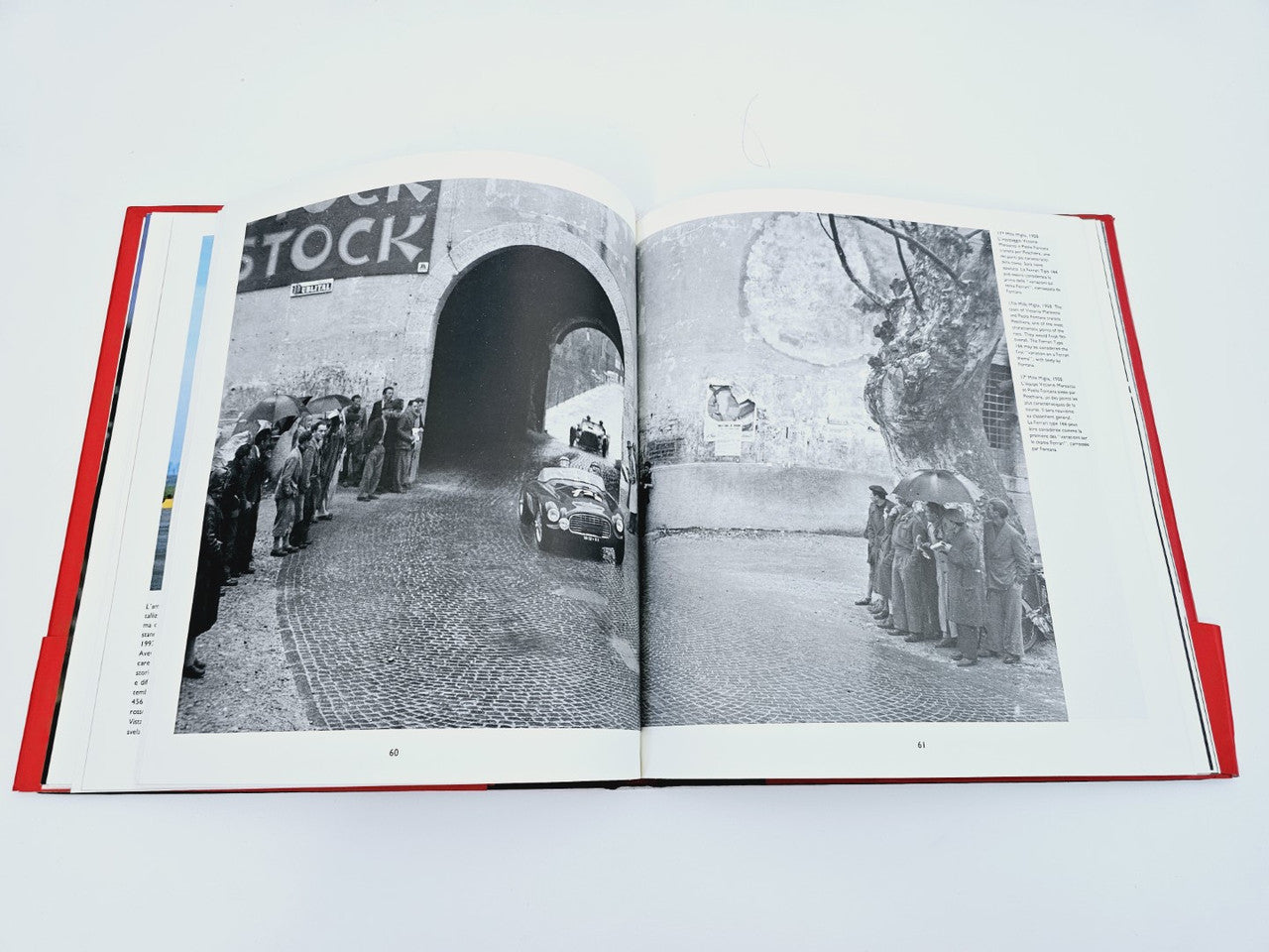 Open book with black-and-white racing scene photos on facing pages