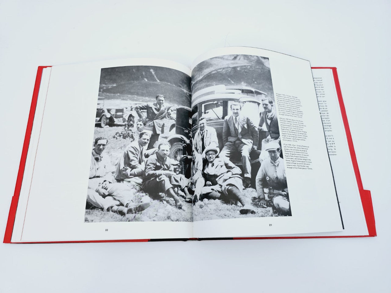 Open book with black-and-white group photo on racing event spread