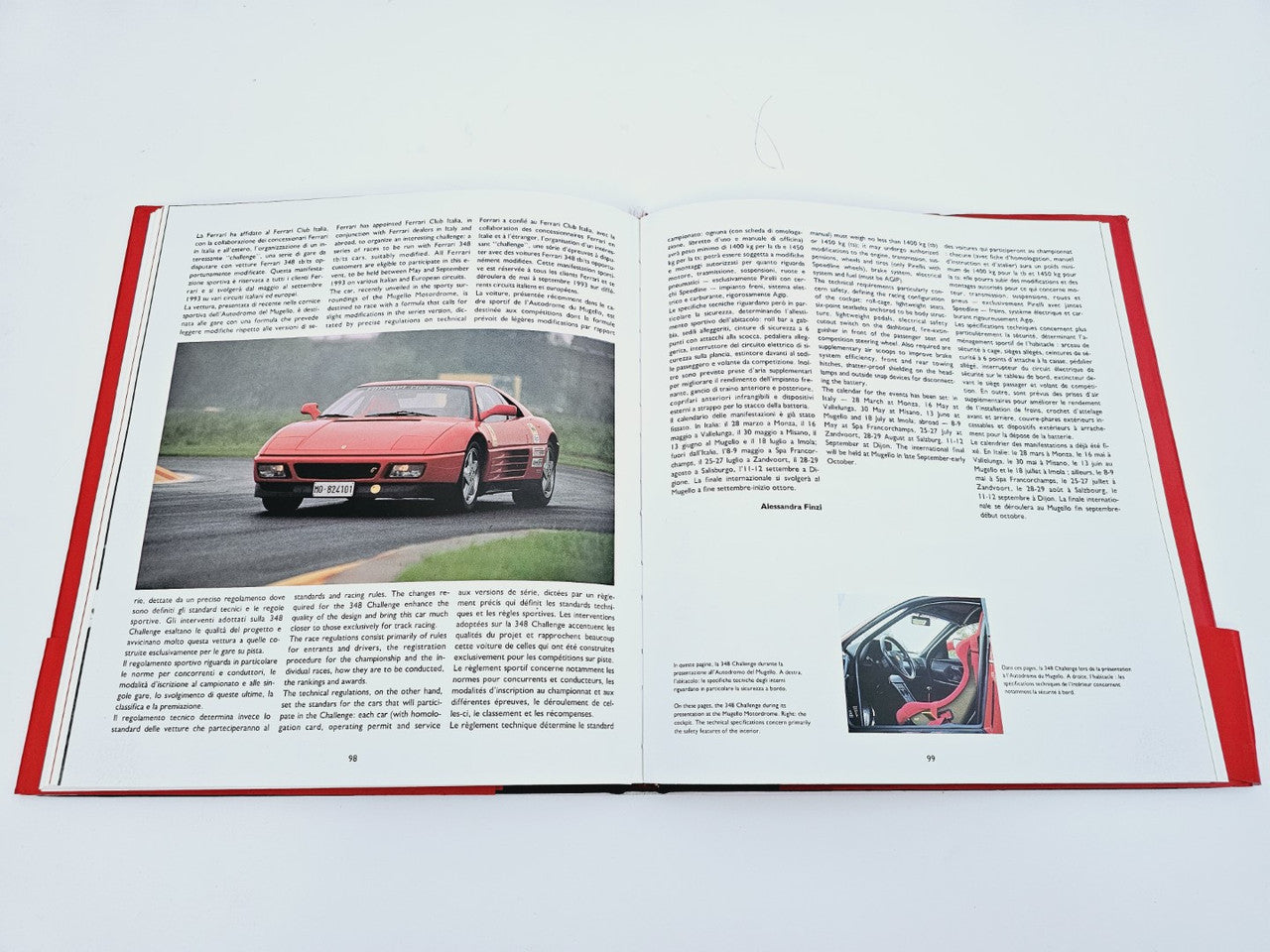 Open book spread with red car photo and dense text on facing pages