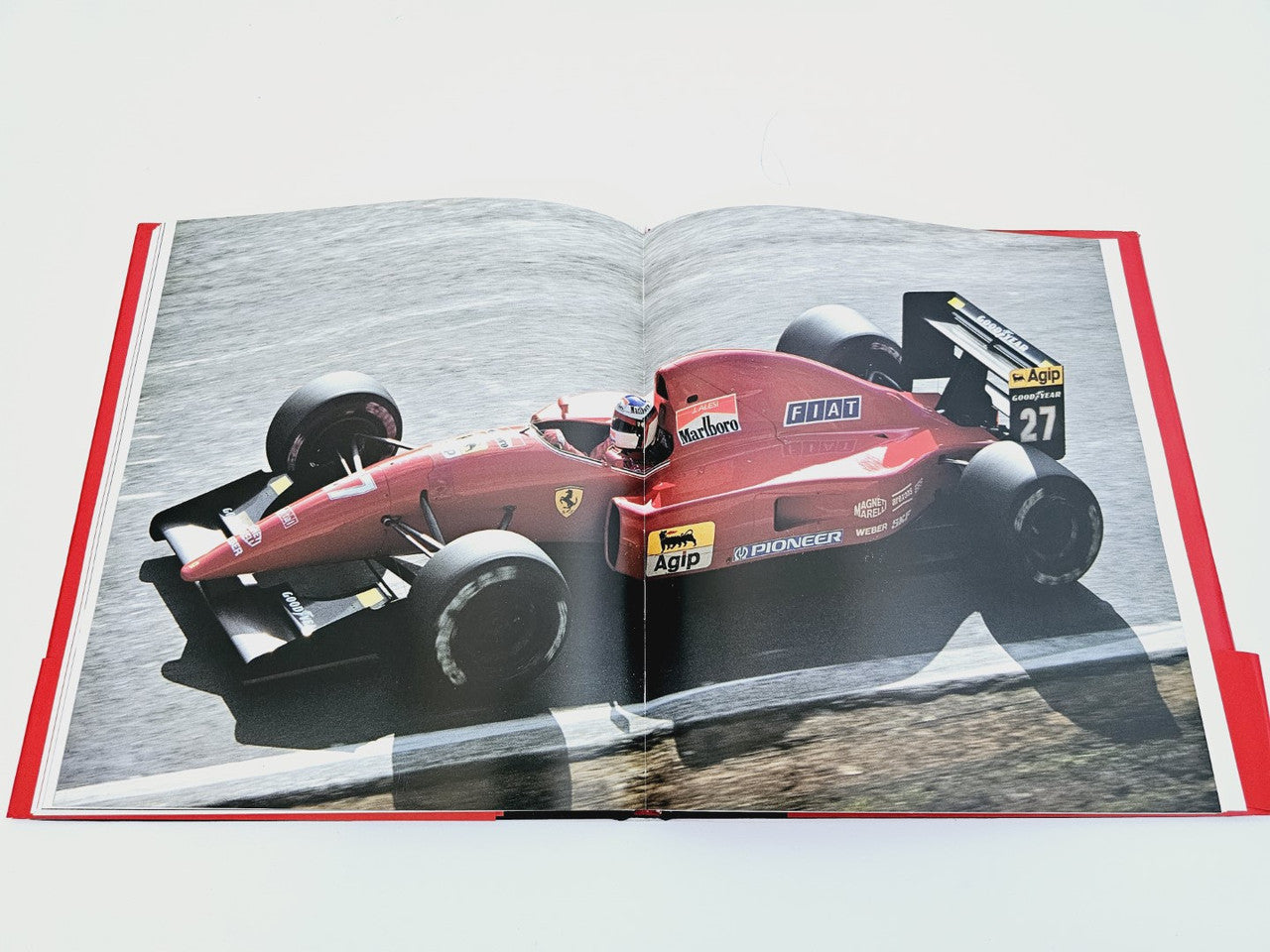 Open book featuring a red Formula car photo on the left page