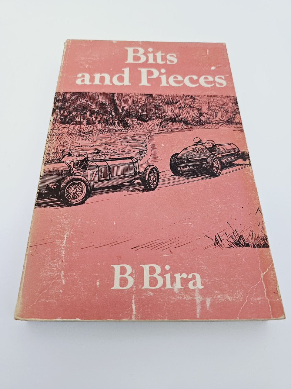 Vintage red book cover titled Bits and Pieces with B Bira name and car illustration