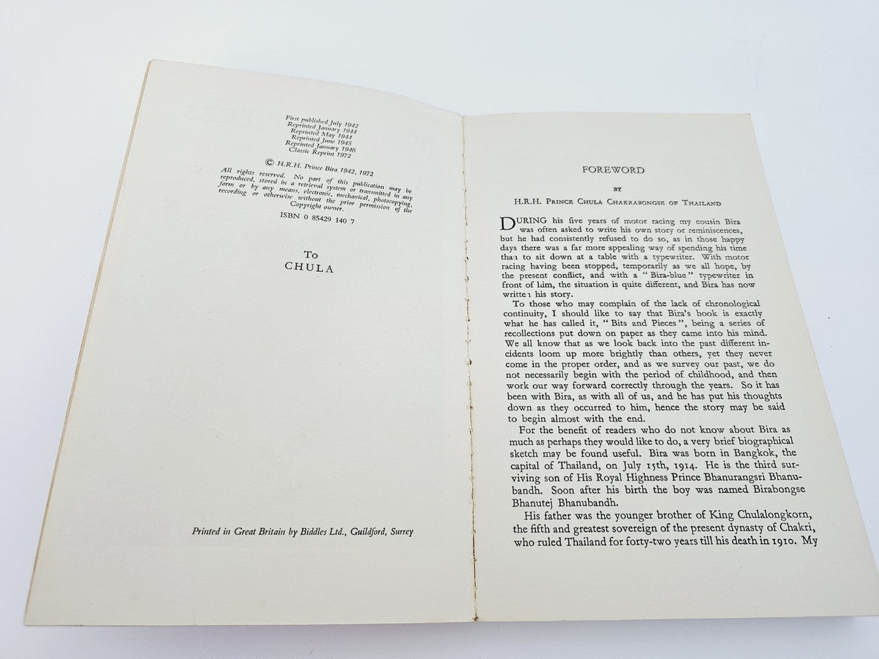 Open book with printed text on both pages, white paper and visible spine