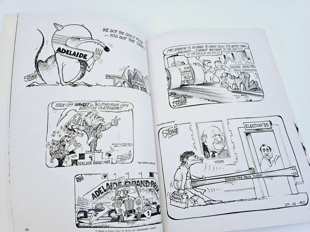 Open book spread with black-and-white cartoon scenes and captions on both pages