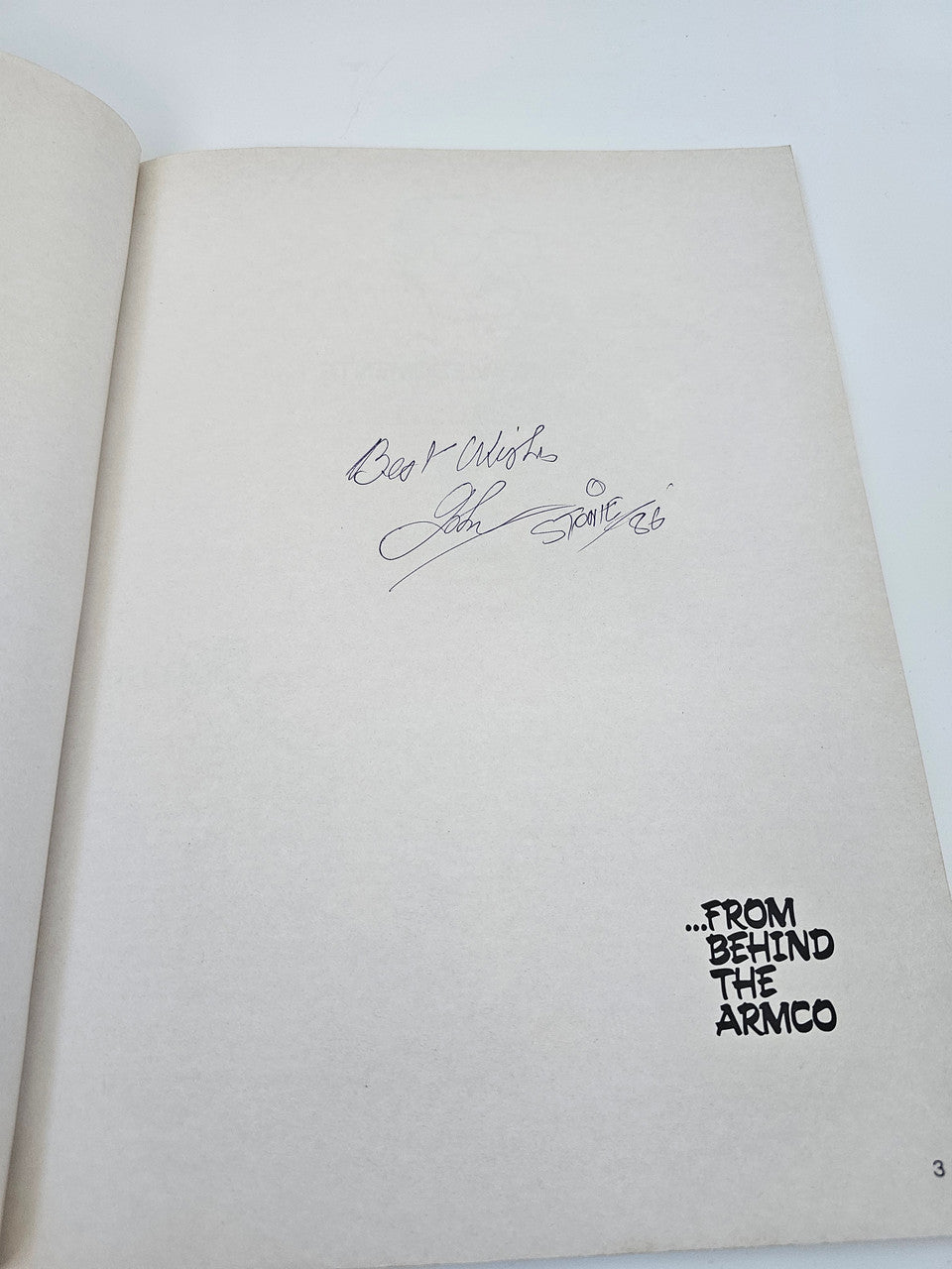 Signed book page with handwritten signature and “From Behind the ARMCO” text