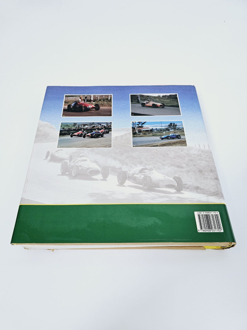 Signed racing history book back cover with four car photos and barcode