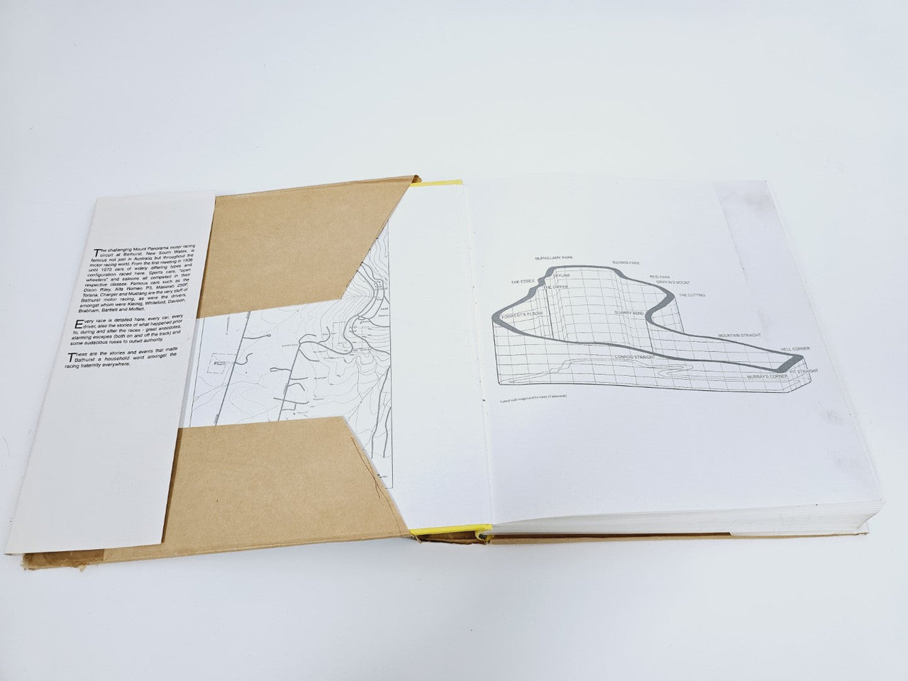Open book spread showing circuit map diagrams and track layout drawings