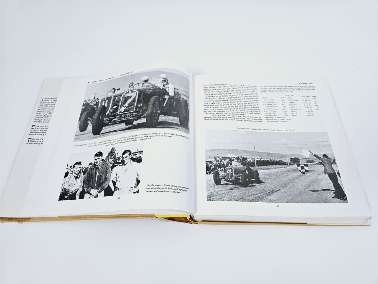 Open book spread with black-and-white race photos and event text