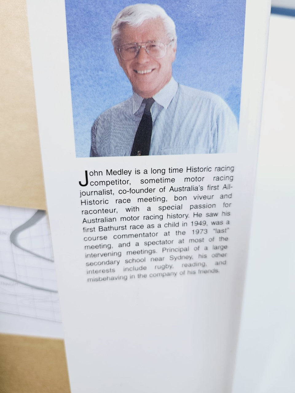 Book page with a man portrait and paragraph text beneath the photo