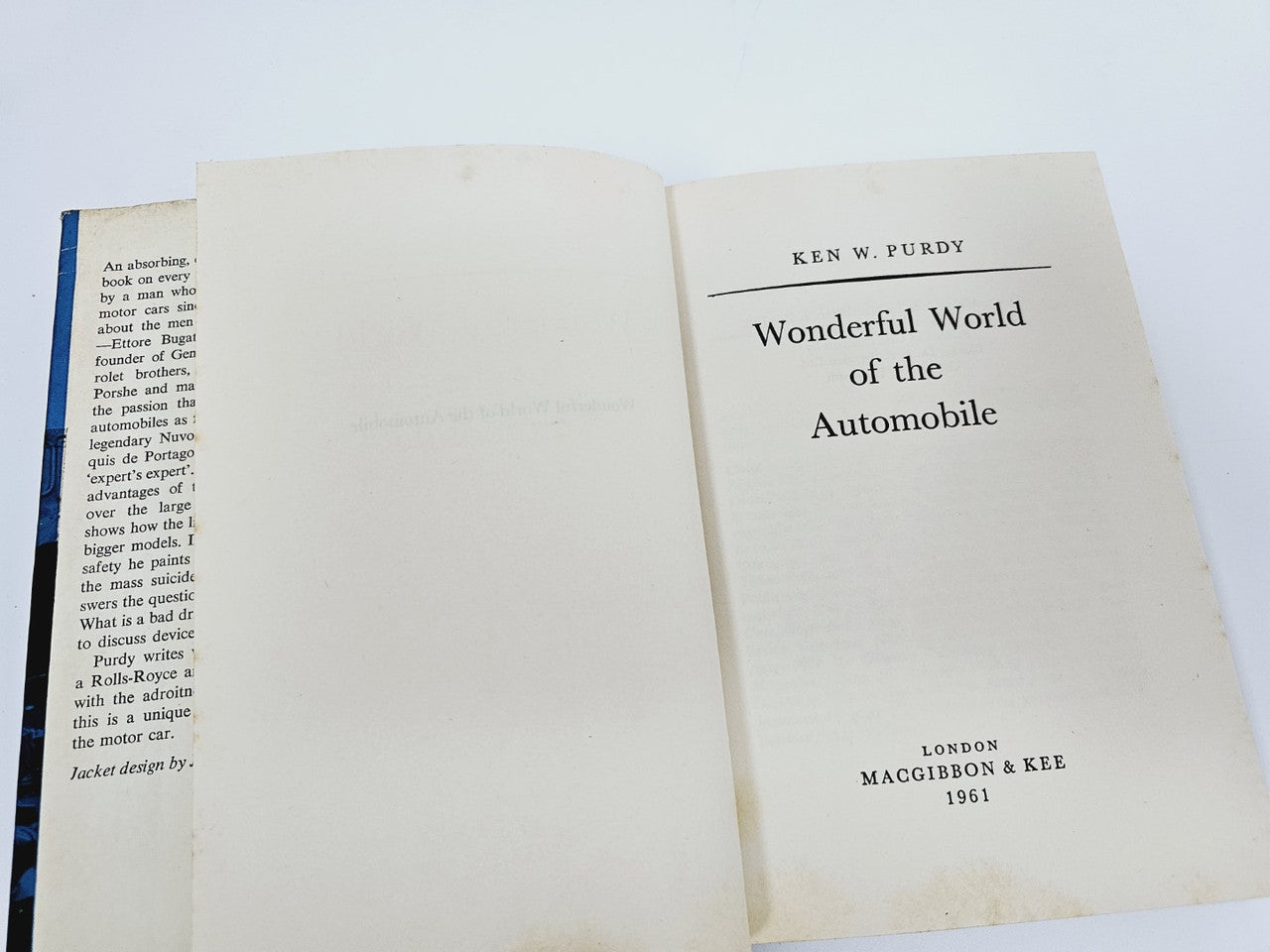 Opened automobile book showing title page: "Wonderful World of the Automobile".