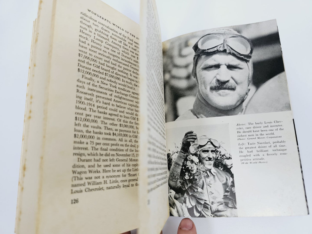 Opened automobile book with printed page and black-and-white portrait photograph.