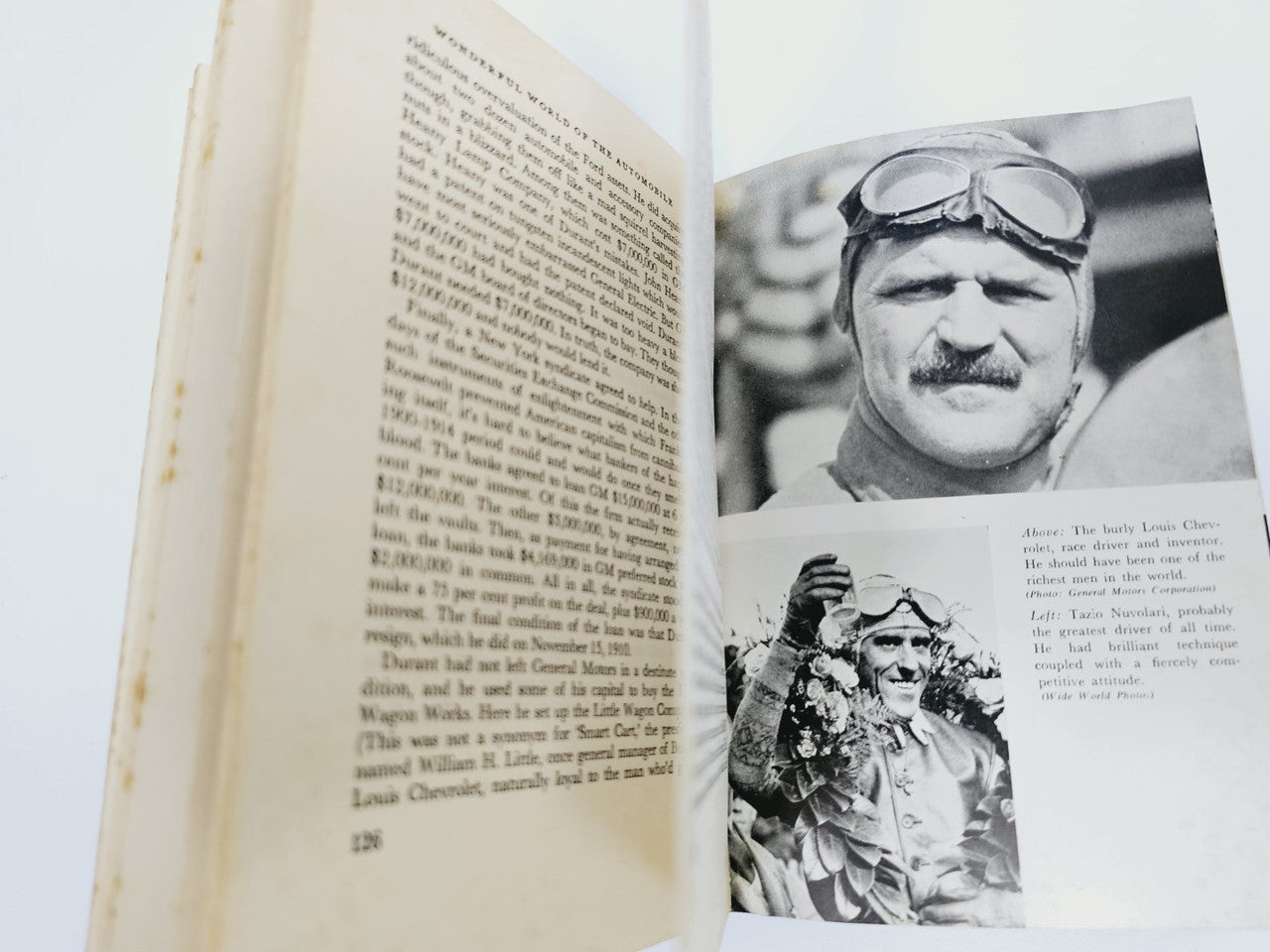 Opened automobile book pages with black-and-white portrait and small photo.
