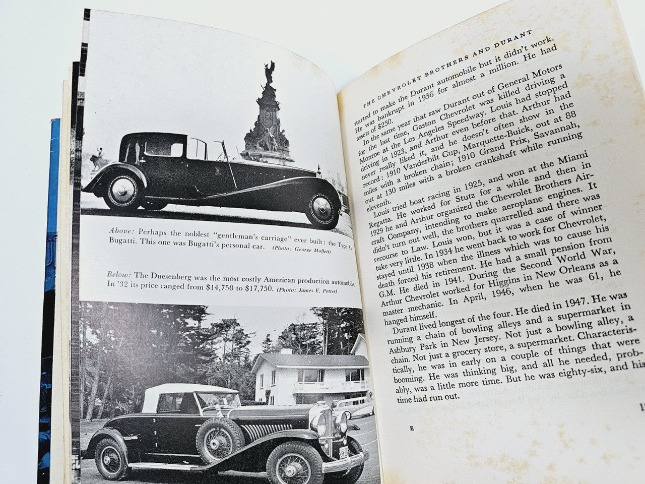 Open hardcover automobile book with black-and-white vintage car photos and text