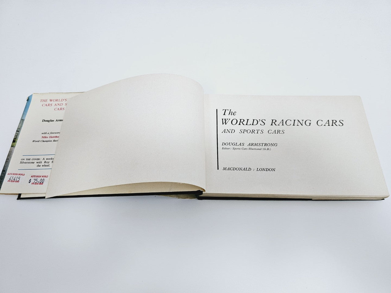 Vintage racing cars book open to title page with centered “The World’s Racing Cars” text