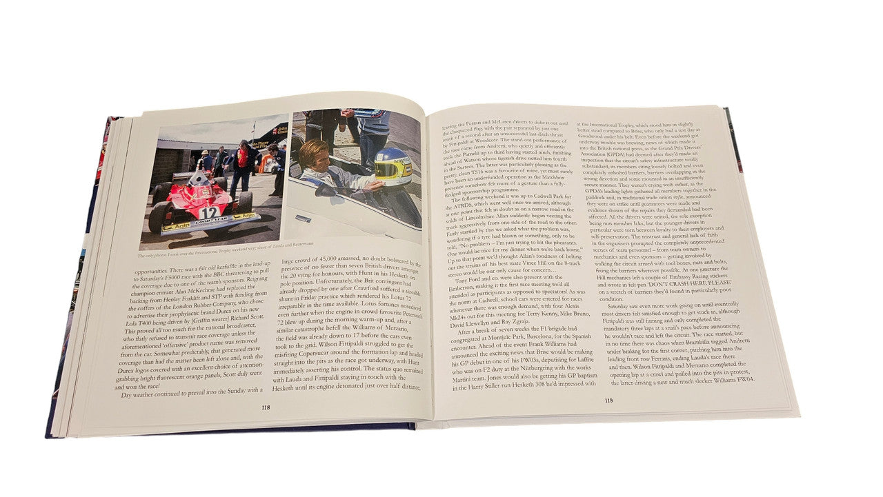 Signed racing history book open to pages with race photos and columns of text