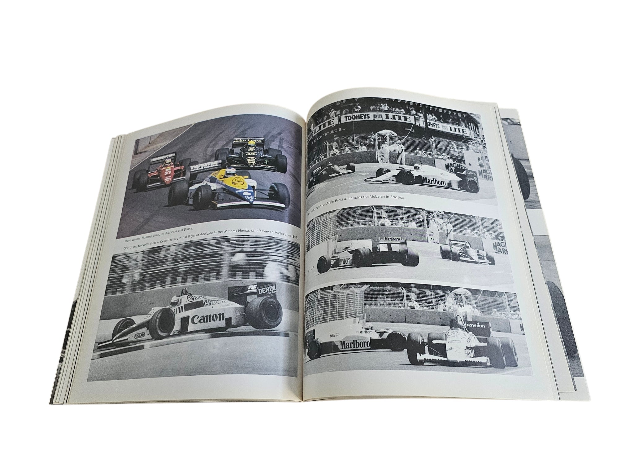 Open motorsport action book with two-page spread of black-and-white race car photos