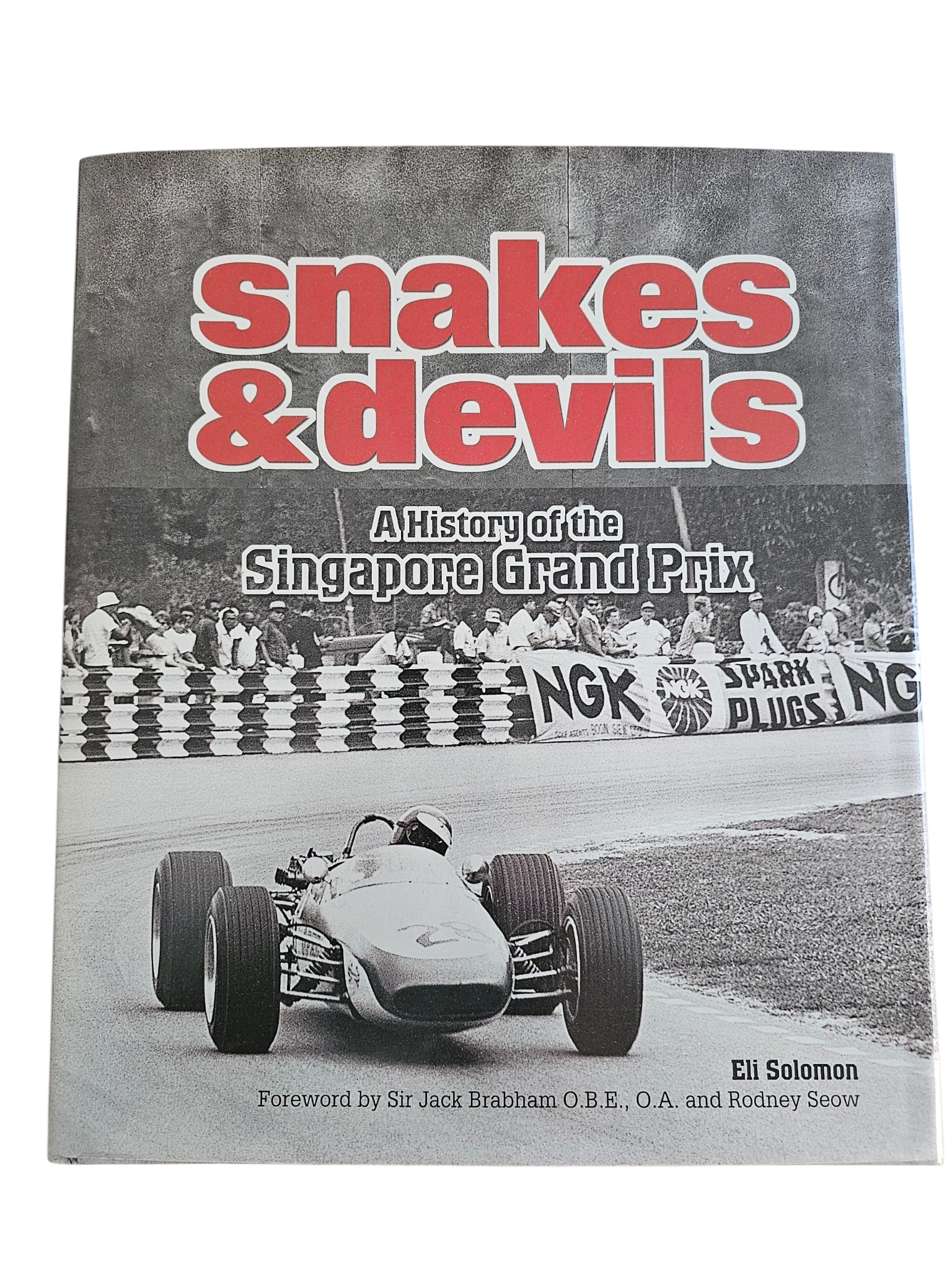 Signed motorsport history book, front cover with title and vintage race car photo
