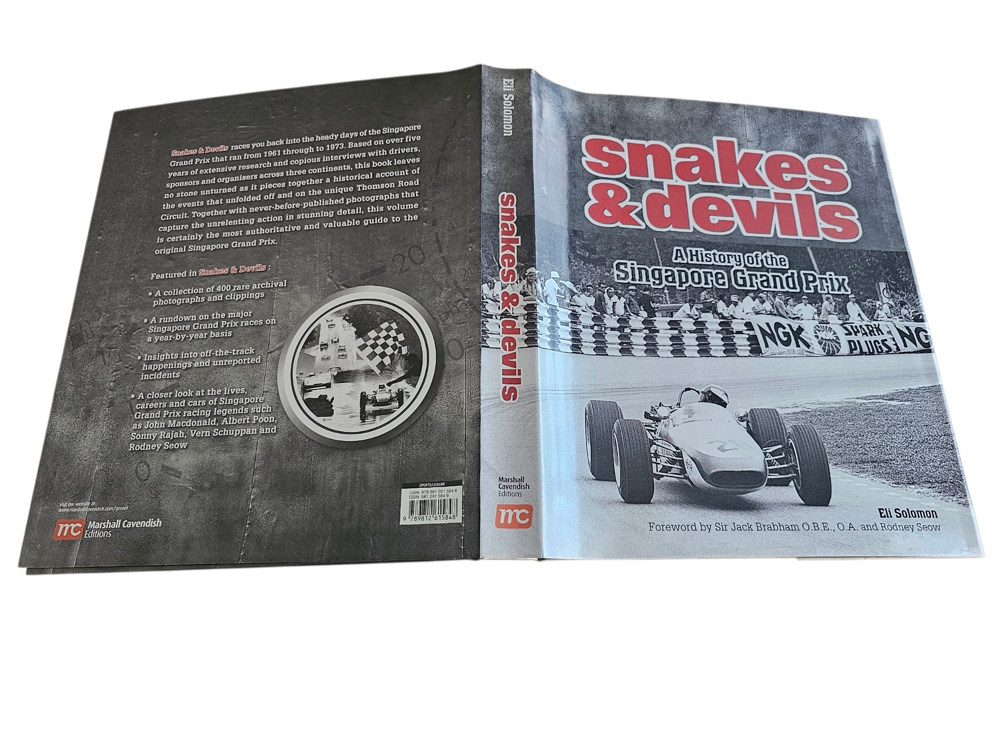 Signed motorsport history book, open view of front and back covers with title