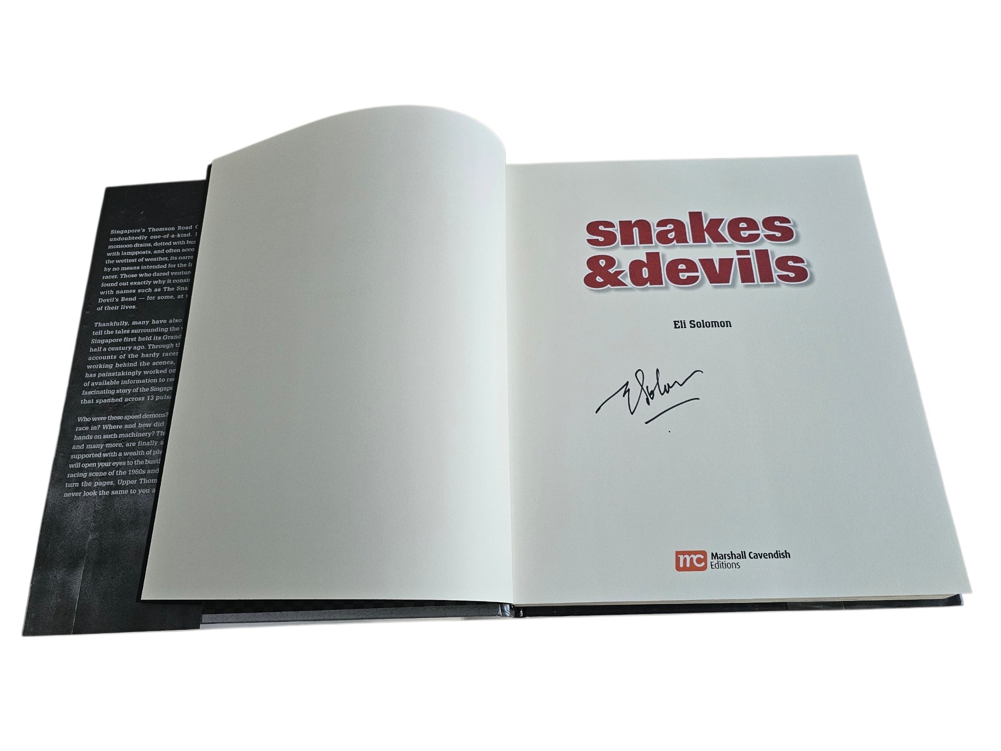 Signed motorsport history book, open pages with handwritten signature on title page