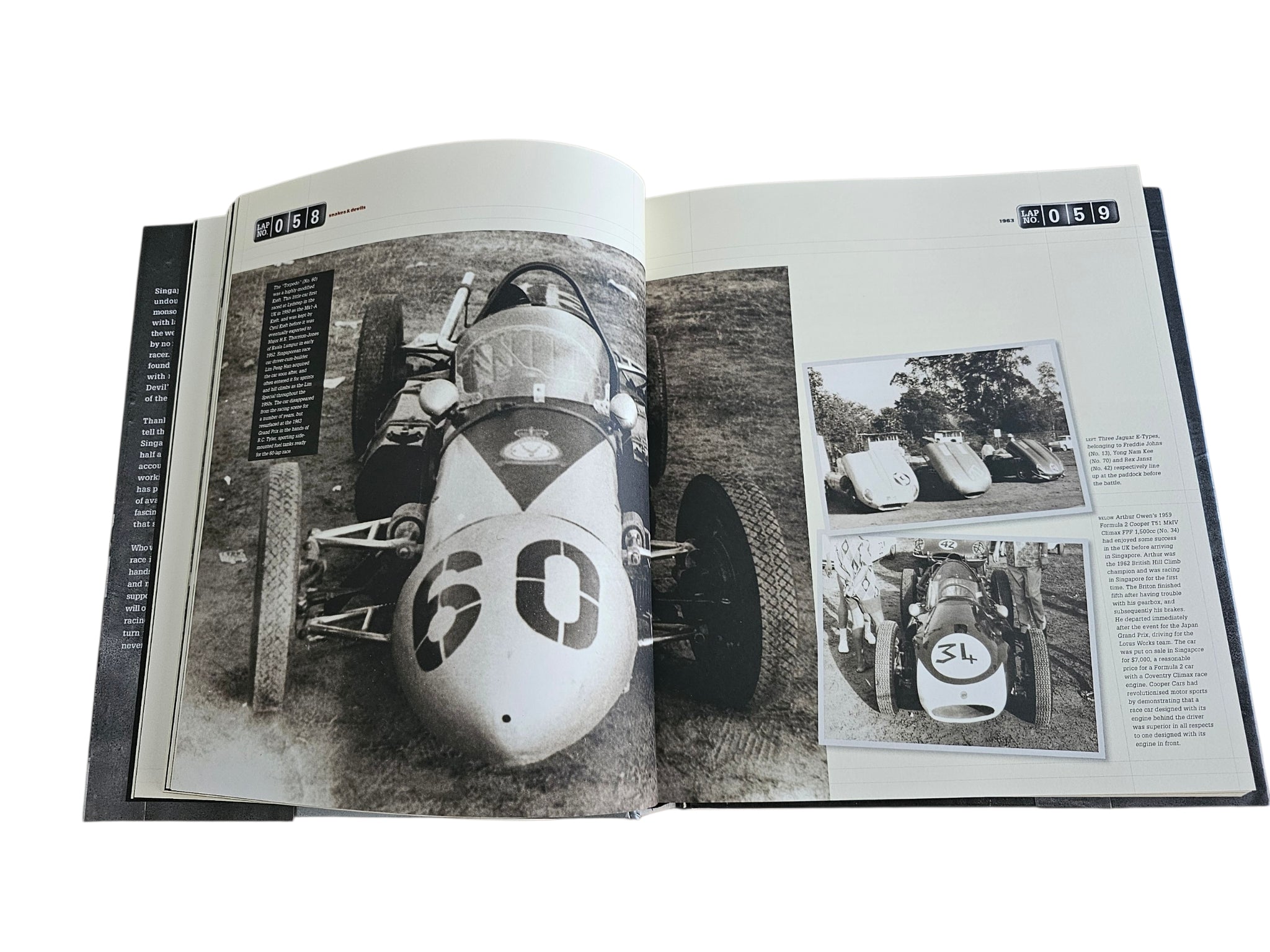 Signed motorsport history book, open spread featuring vintage race car close-up photos