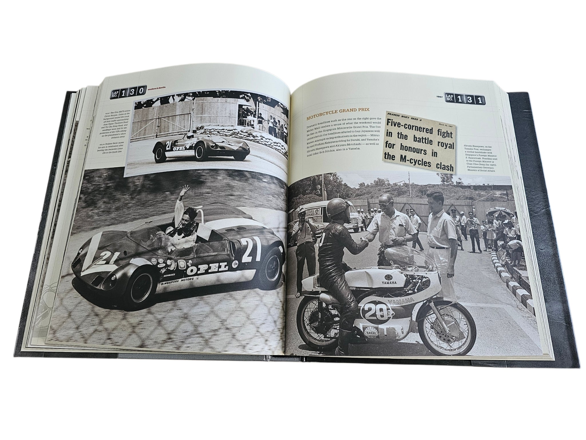 Signed motorsport history book, open spread with classic cars and track photographers