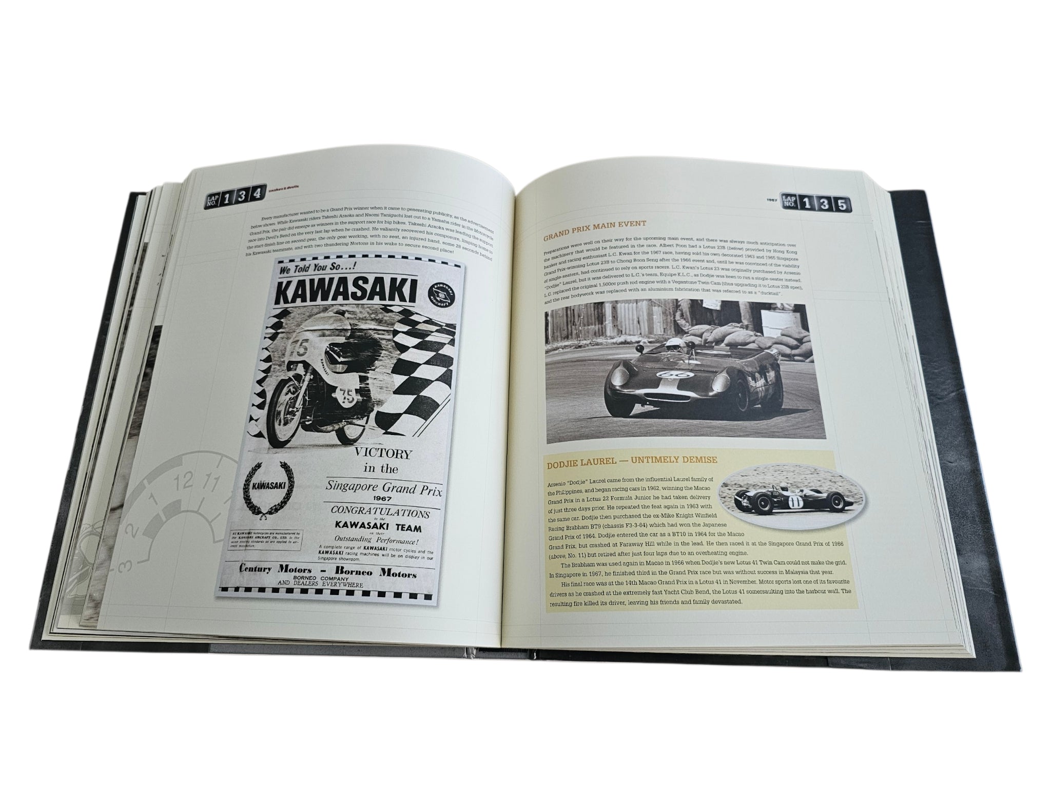 Signed motorsport history book, open spread with Kawasaki-related page graphics and text