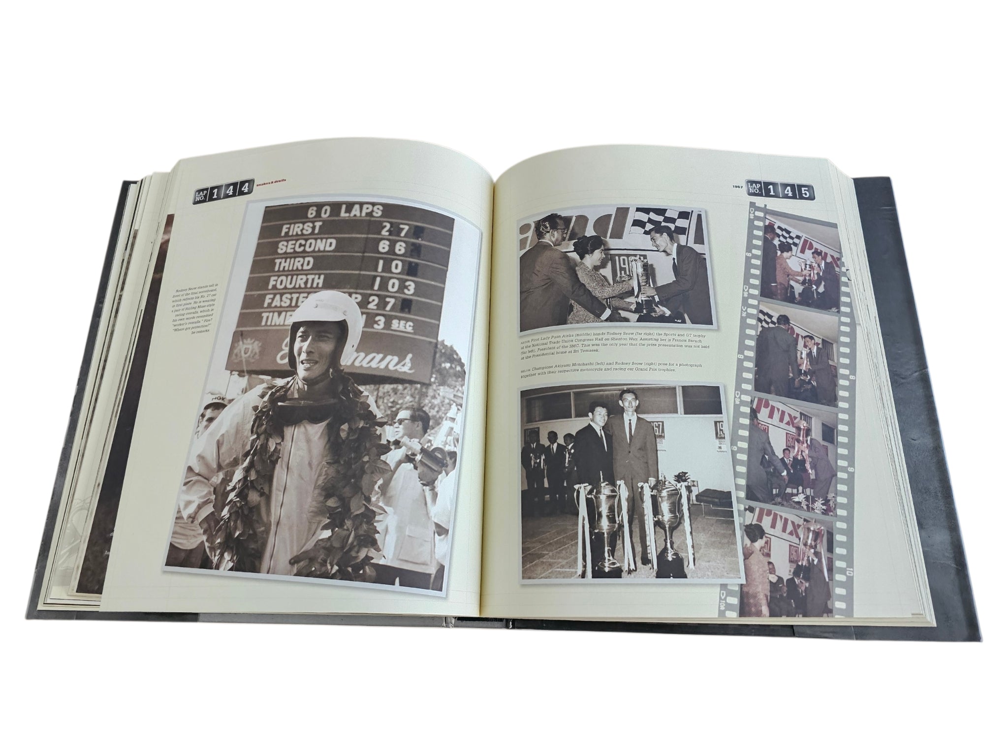 Signed Singapore Grand Prix history book, open to photos and race results pages