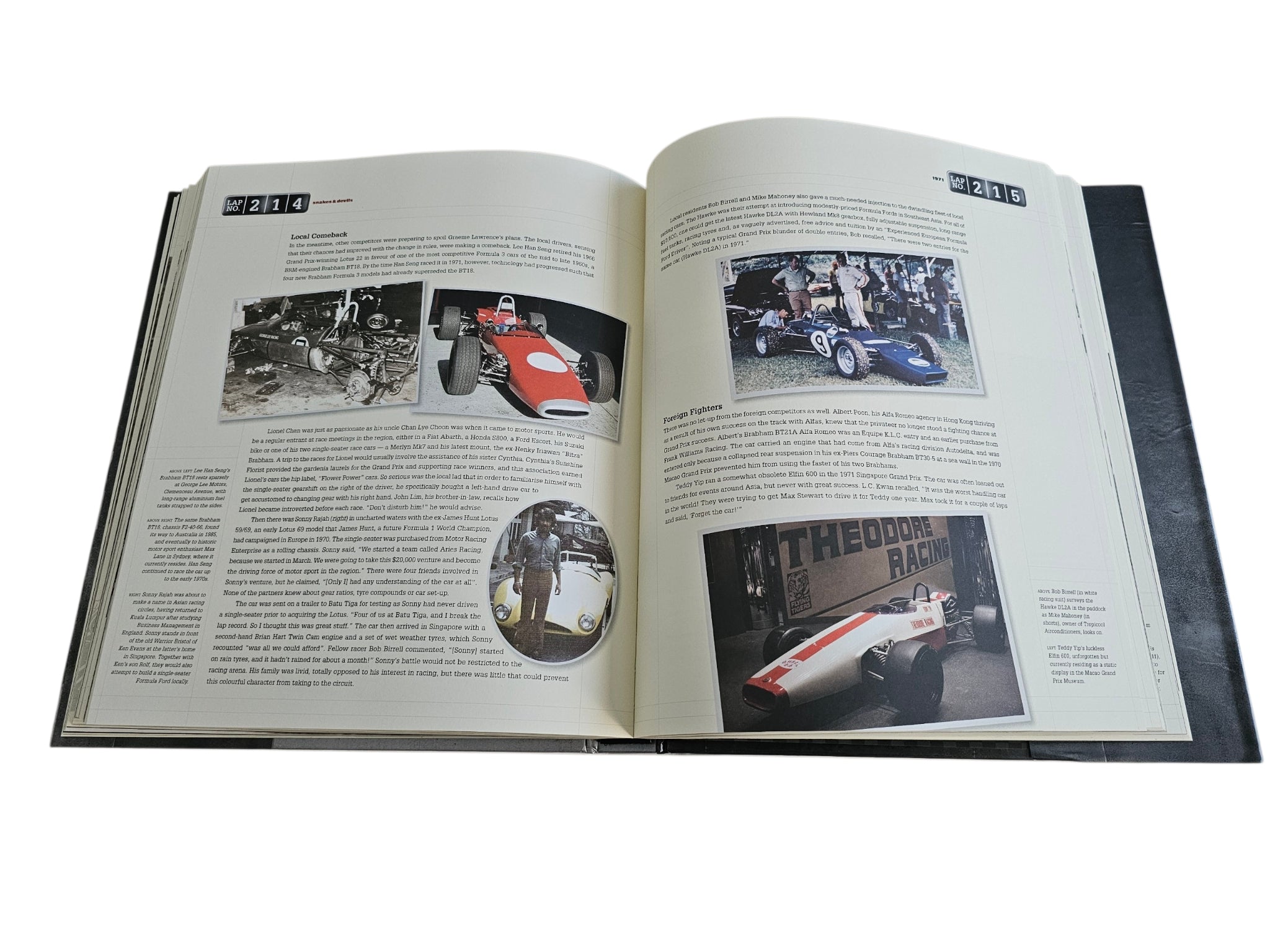 Signed motorsport history book, open spread with racing photos and inset images