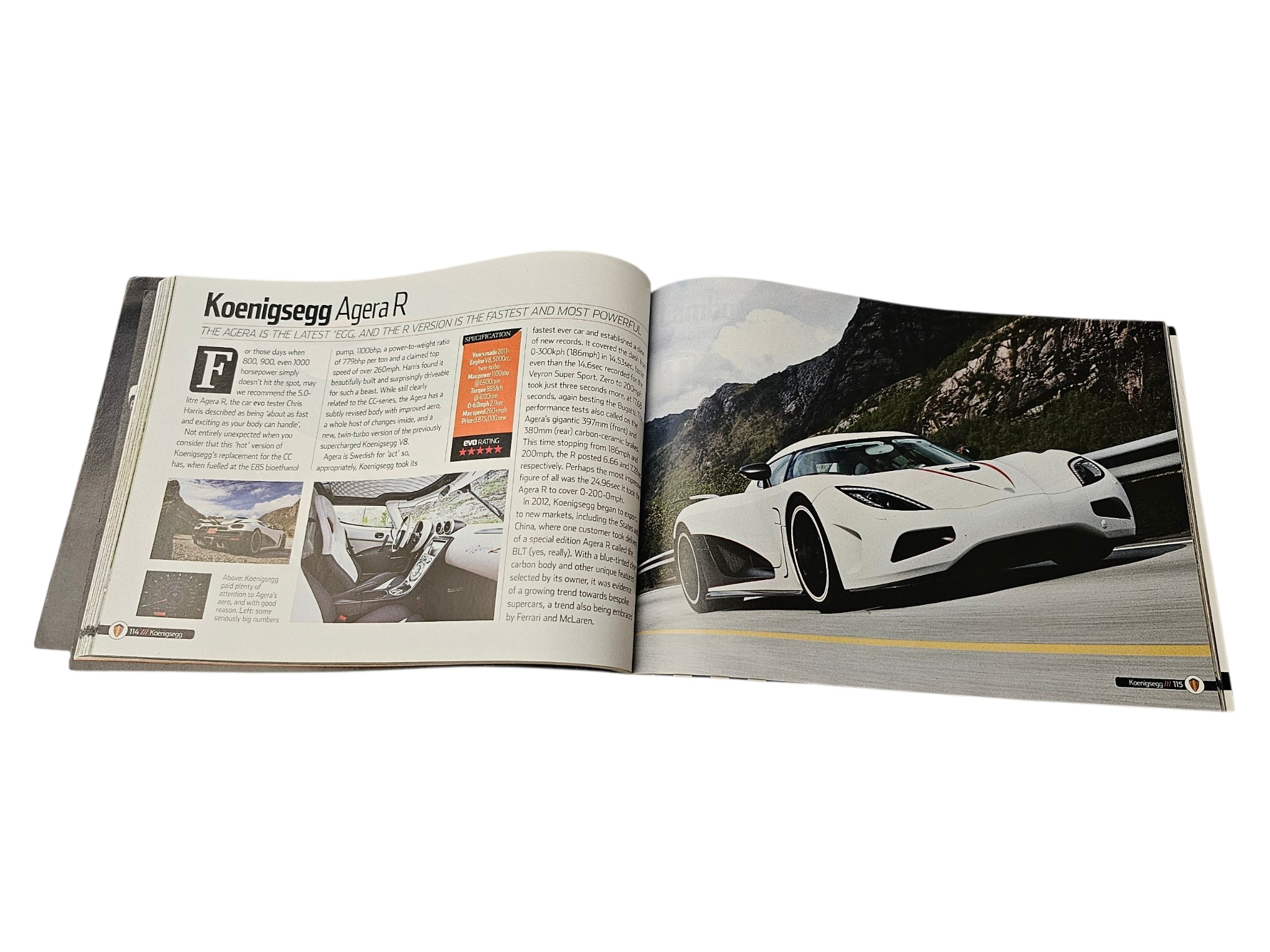 Supercar guide book open spread with green landscape and white sports car page